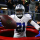 Ezekiel Elliott, No. 21 of the Dallas Cowboys, celebrates Dec. 18, 2016, after scoring a touchdown by jumping into a large Salvation Army red kettle during the second quarter of a game against the Tampa Bay Buccaneers in Arlington, Texas.
Tom Pennington/Getty Images